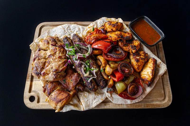 Full-board camp meal of grilled meats and sides